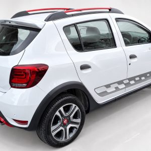 A-445_2jpg - OPSHOLDERS White Dacia compact SUV photographed from rear-left side, showing badge, taillight, roof rails, and rear wheel arch