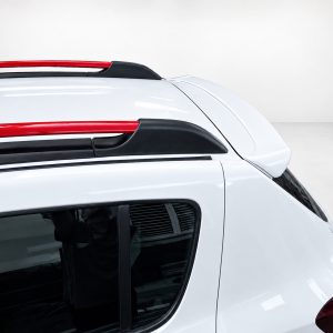 A-445_4jpg - OPSHOLDERS Close-up of the top rear section of a white car with red roof rails and black roof rack mounts.