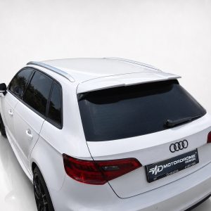 White Audi SUV shown from the rear-left angle in a studio setting, with visible rear spoiler, taillights, and glossy black tainted rear window.