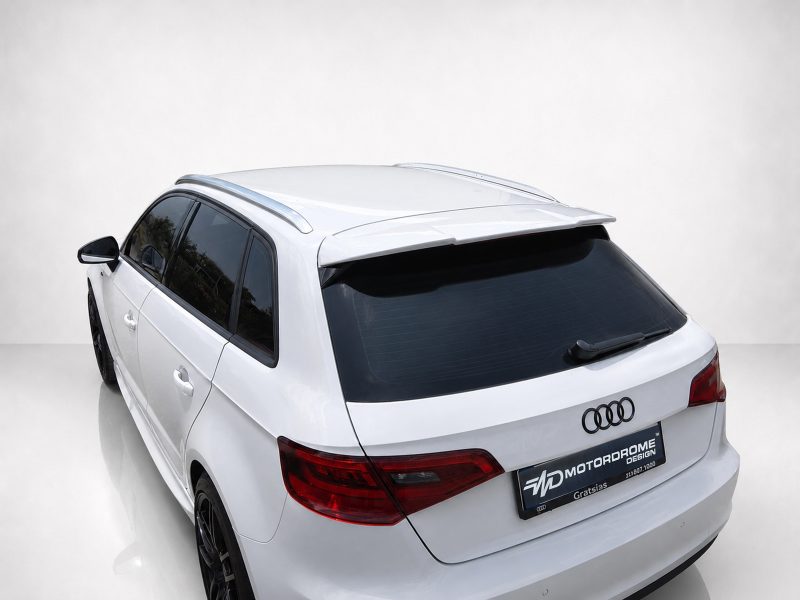 White Audi SUV shown from the rear-left angle in a studio setting, with visible rear spoiler, taillights, and glossy black tainted rear window.
