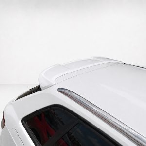 White car roof with spoiler seen from above, showing sleek lines and chrome trim against a pale background.