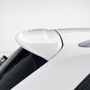 Close-up of a white car's rear spoiler mounted above the rear window, showing aerodynamic curves and glossy finish.