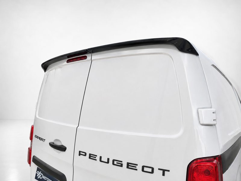 Rear view of a white Peugeot Expert van with a black roof spoiler and red tail lights visible on the right edge.