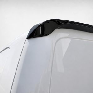 Close-up of a white car's rear end with a glossy black spoiler and red taillight detail on the right.