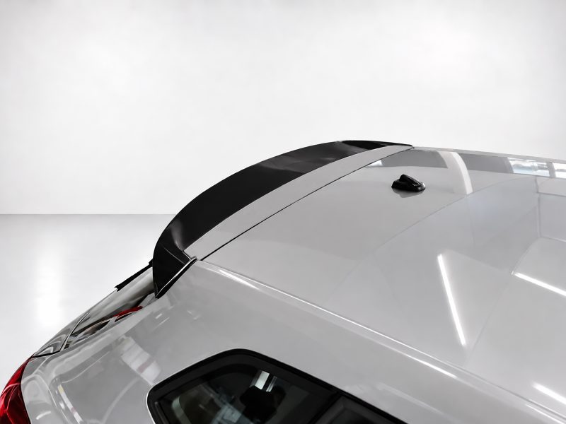 A-451_3jpg - OPSHOLDERS Close-up of a silver car roof showing a small black antenna mounted near the center edge of the roof (shark-fin style).