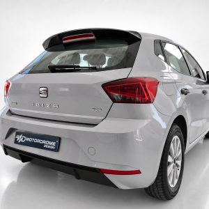 A-451_5jpg - OPSHOLDERS Rear three-quarter view of a silver SEAT Ibiza hatchback in a studio, showing taillights and badges (Ibiza, TSI).
