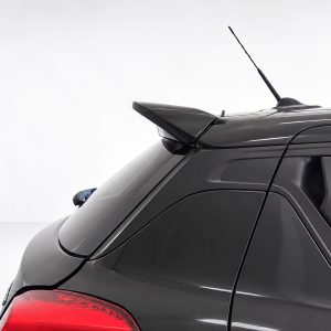 Black SUV rear with a roof spoiler, antenna, and red taillights visible on a light backdrop