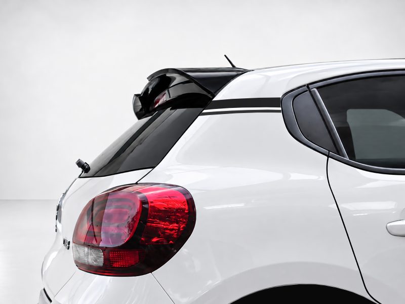 White hatchback rear with black spoiler, taillight, and racing stripe along window line.