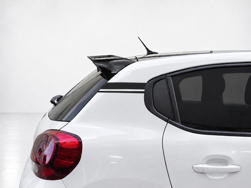 White hatchback rear with a black spoiler, tinted rear window, and red tail light highlight the back of the car with a sporty look.