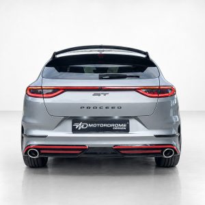 Rear view of a silver SUV hatchback with full-width taillights, 'PROCEED' lettering, and dual exhausts; Motordrome Design plate visible at the bumper edge.