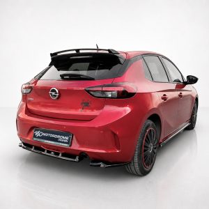 A-456_2jpg - OPSHOLDERS Red Opel Corsa hatchback seen from the rear-left side with a sport rear diffuser and black spoiler, displaying a showroom-like backdrop and a custom 'Motordrome Design' plate.