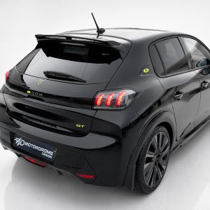 A-456_3-1jpg - OPSHOLDERS Rear three-quarter view of a glossy black electric hatchback with red taillights and yellow GT badge in a white studio setting