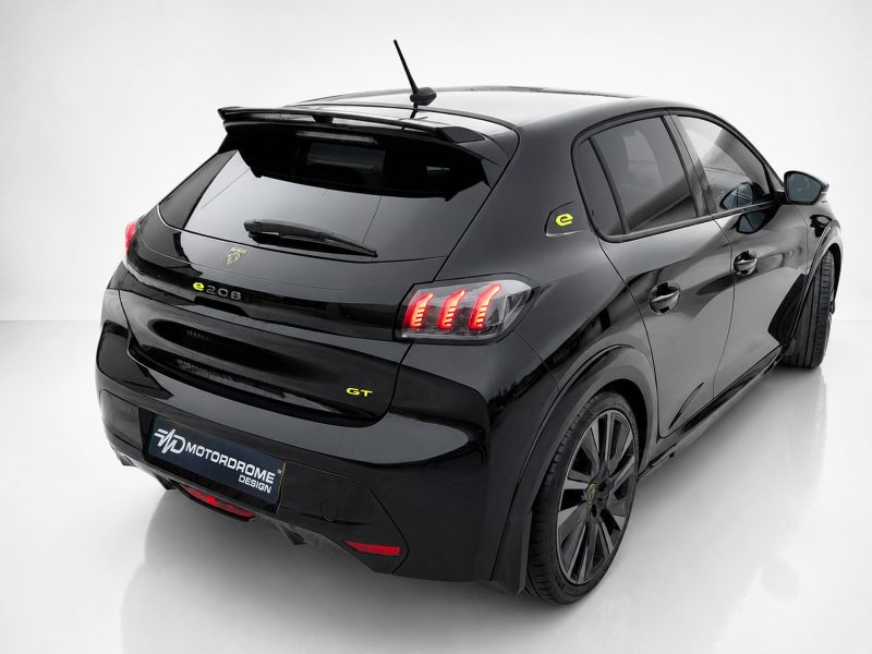 A-456_3-1jpg - OPSHOLDERS Rear three-quarter view of a glossy black electric hatchback with red taillights and yellow GT badge in a white studio setting