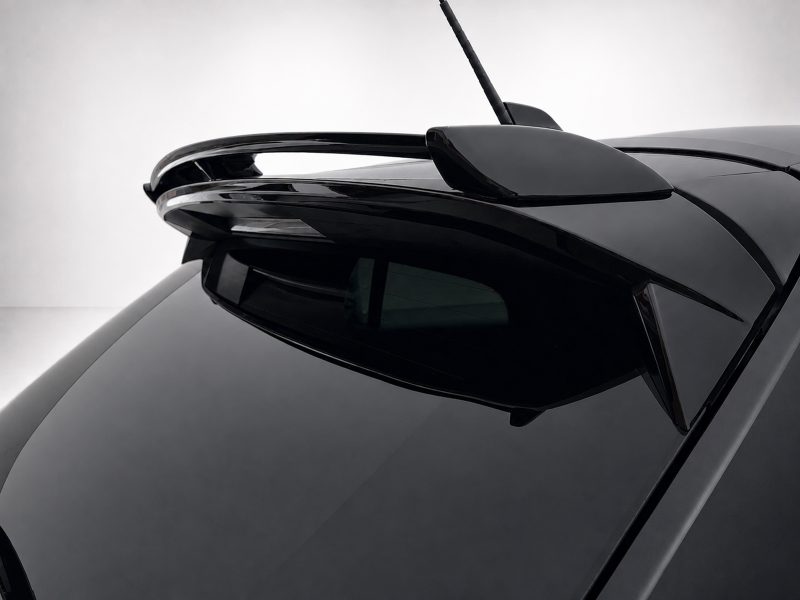 A-456_4-1jpg - OPSHOLDERS Close-up of a black car roof showing a sleek rear spoiler and antenna.