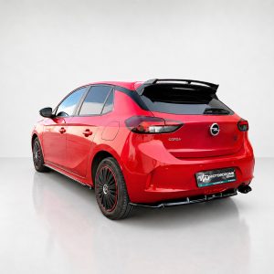 A-456_5jpg - OPSHOLDERS Red Opel Corsa hatchback shown from the rear-left in a bright studio setting with a glossy finish and spoiler details