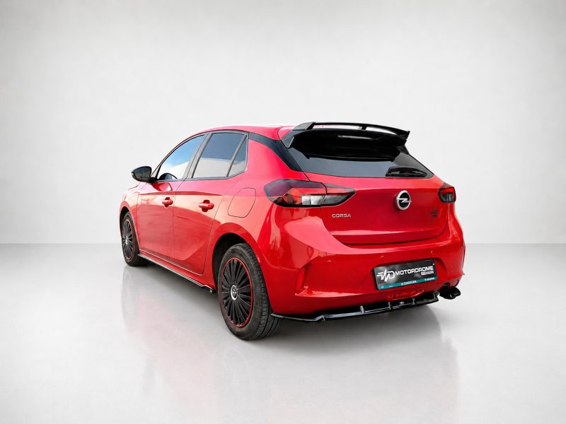 A-456_5jpg - OPSHOLDERS Red Opel Corsa hatchback shown from the rear-left in a bright studio setting with a glossy finish and spoiler details
