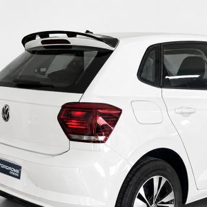 Rear three-quarter view of a white Volkswagen SUV with a roof spoiler, visible tail light, and alloy wheels on display.