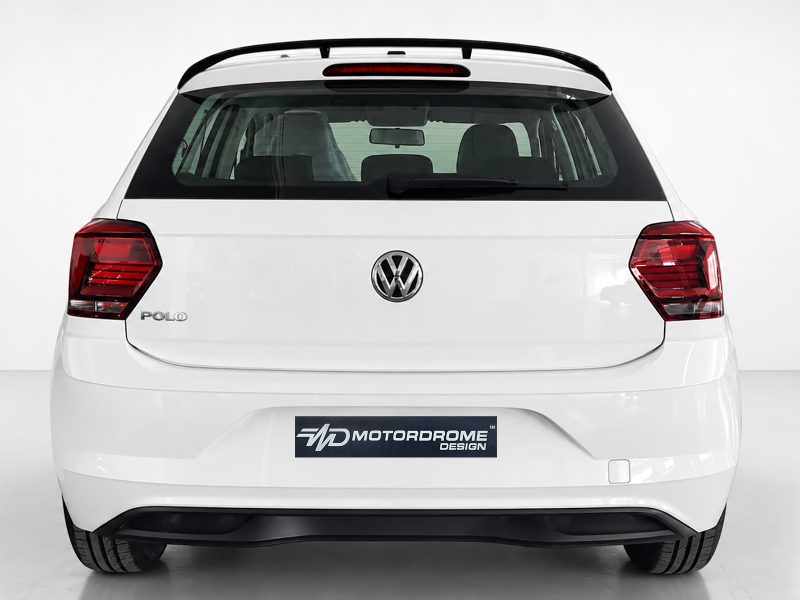 A-457_3jpg - OPSHOLDERS Rear view of a white Volkswagen Polo with VW badge, showing taillights and Motordrome Design plate on the bumper.