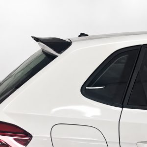 A-457_4jpg - OPSHOLDERS Rear quarter view of a white SUV showing a black roof spoiler and rear window/taillight area--focus on the spoiler.