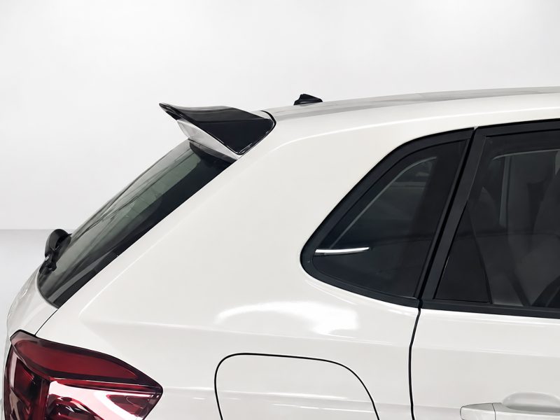 A-457_4jpg - OPSHOLDERS Rear quarter view of a white SUV showing a black roof spoiler and rear window/taillight area--focus on the spoiler.