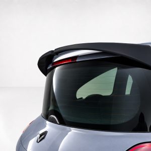 Rear view of a silver Renault hatchback with a black rear spoiler and red taillight behind the glass window.