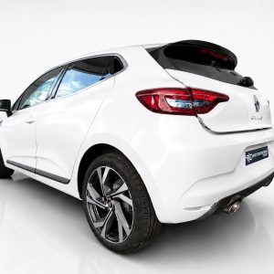 A-460_2jpg - OPSHOLDERS Rear three-quarter view of a white hatchback car in a studio setting, highlighting its taillights and alloy wheels with a glossy floor.