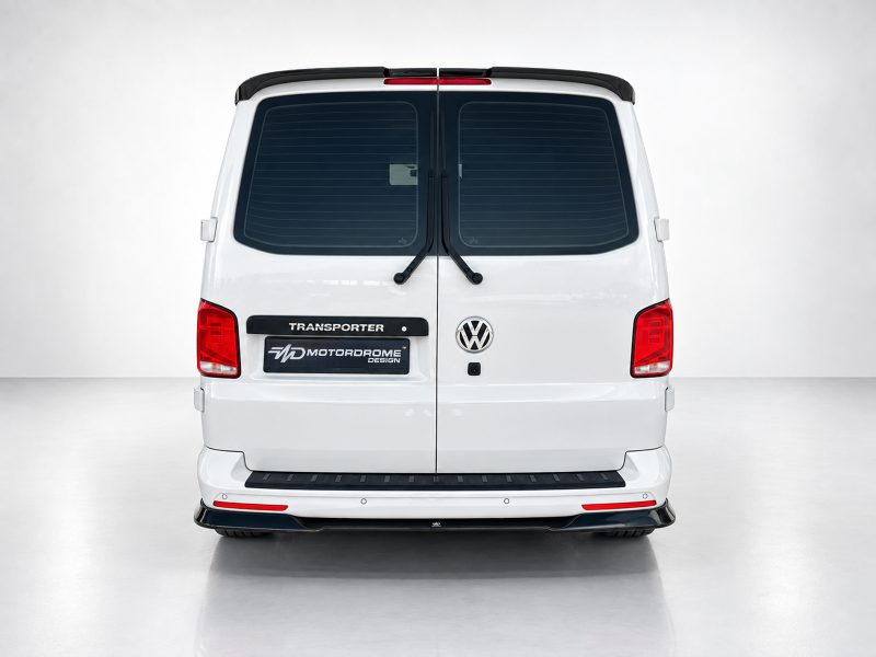 Rear view of a white Volkswagen Transporter van in a studio setting with two rear doors and wiper blades visible behind the glass.