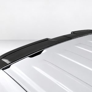 Close-up of a black rear spoiler installed on a white car, highlighting its aerodynamic design along the trunk edge with glossy finishich reflections.