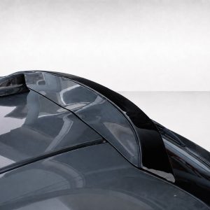 A-463_3jpg - OPSHOLDERS Close-up of a dark glossy sports car hood and cockpit with curved windshield reflections.