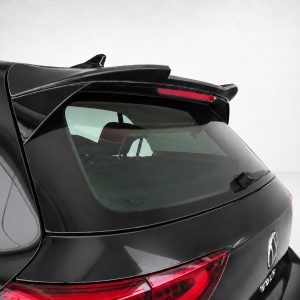 Close-up of the rear end of a black SUV with a roof spoiler and red taillights