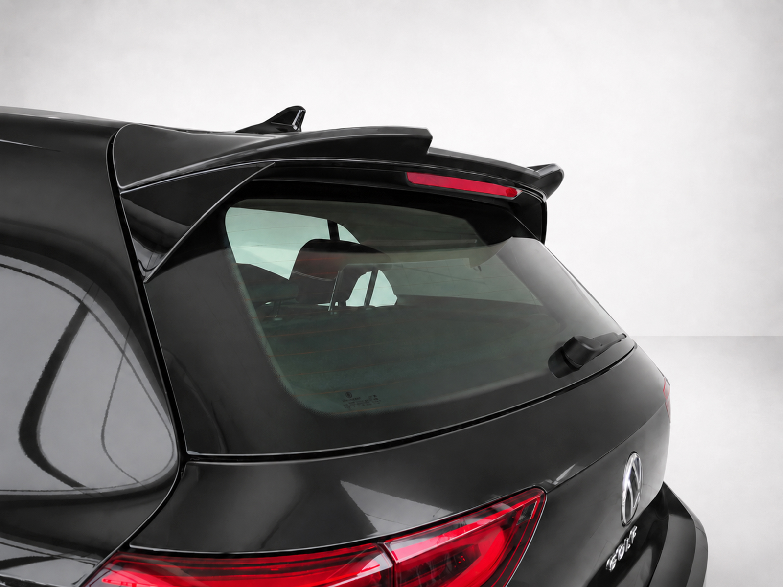 A-464_1jpg - OPSHOLDERS Close-up of the rear end of a black SUV with a roof spoiler and red taillights