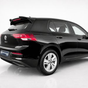 A-464_2jpg - OPSHOLDERS Black Volkswagen Golf hatchback seen from rear three-quarter view in a white studio, highlighting taillights and glossy finish.