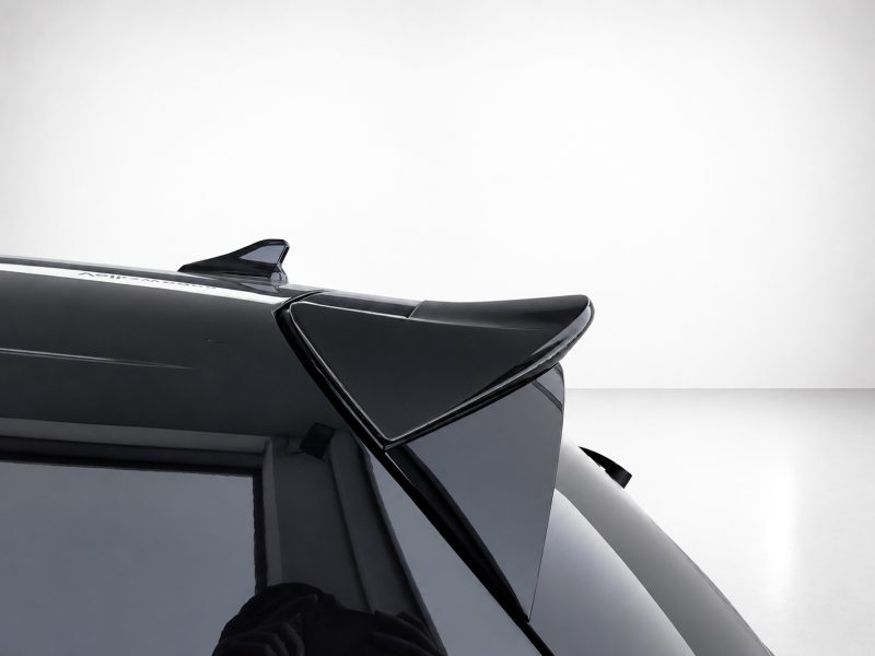 A-464_3jpg - OPSHOLDERS Close-up of a glossy black car rear spoiler and roof edge, highlighting aerodynamic design.