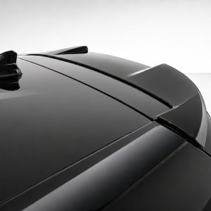 A-464_4jpg - OPSHOLDERS Close-up of a sleek car hood with glossy black panels and aerodynamic lines, emphasizing a modern sports car profile on a light background.
