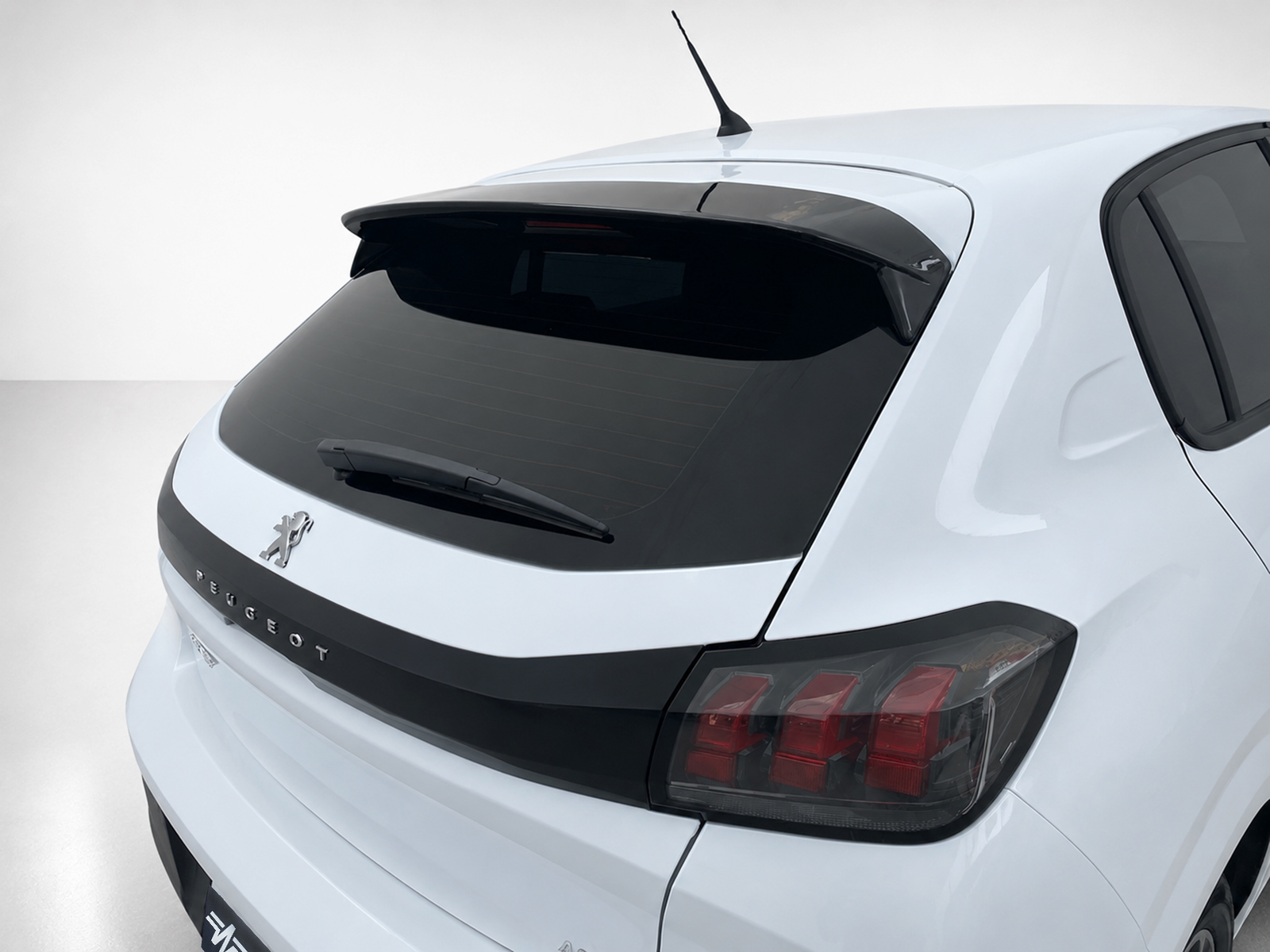 A-465_1jpg - OPSHOLDERS White Peugeot hatchback rear view featuring a rear wiper, small spoiler, antenna, and distinctive taillights.