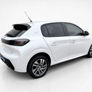 A-465_3jpg - OPSHOLDERS Rear-left view of a white hatchback car in a studio setting, with tinted rear windows and alloy wheels from a low angle.