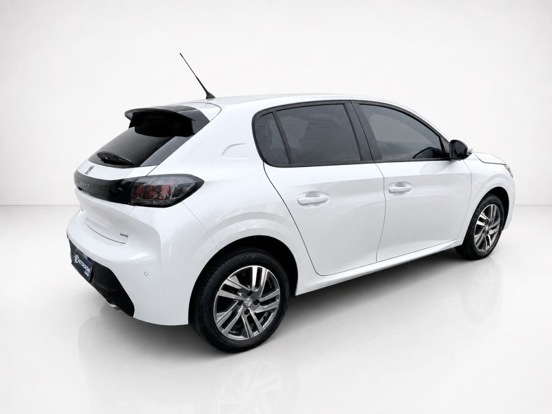 A-465_3jpg - OPSHOLDERS Rear-left view of a white hatchback car in a studio setting, with tinted rear windows and alloy wheels from a low angle.
