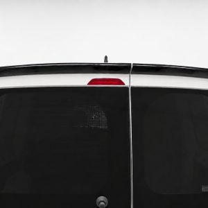 Rear view of a white van with split back doors, dark windows, central seam, and red third brake light above the doors.