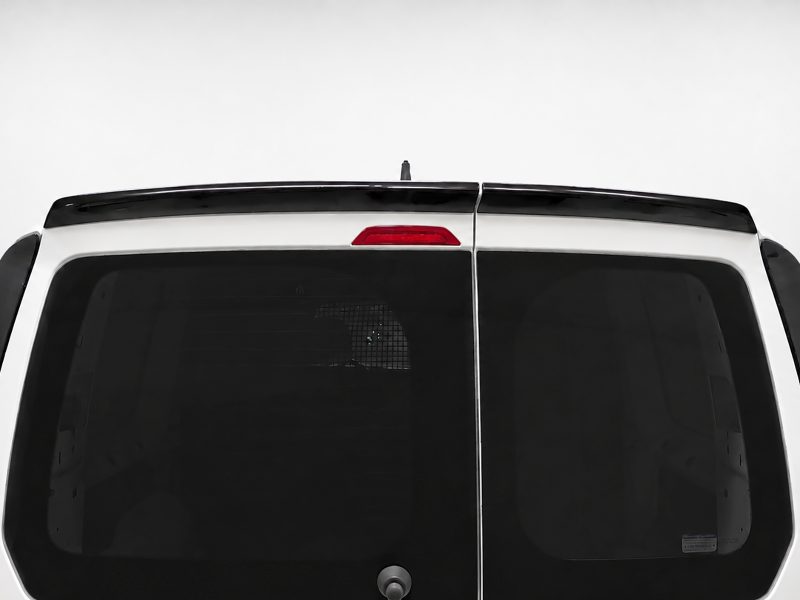 Rear view of a white van with split back doors, dark windows, central seam, and red third brake light above the doors.