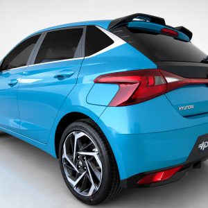 Blue Hyundai hatchback shown from the rear-right side in a studio setting, highlighting taillights and rear design.