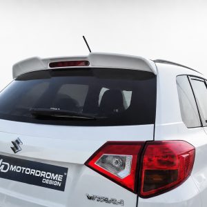 Rear view of a white Suzuki Vitara SUV with a roof spoiler and dark rear window; MD Motordrome Design sticker on the bumper plate area.