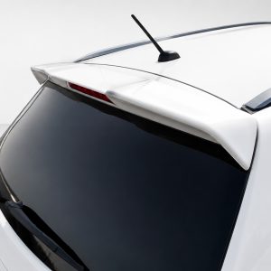 Rear end of a white hatchback showing a spoiler, antenna, and dark tinted rear window against a light background.