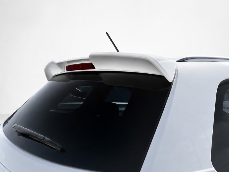 Rear view of a white car showing a spoiler, red brake light, antenna, and dark rear window/s, taken from above left side