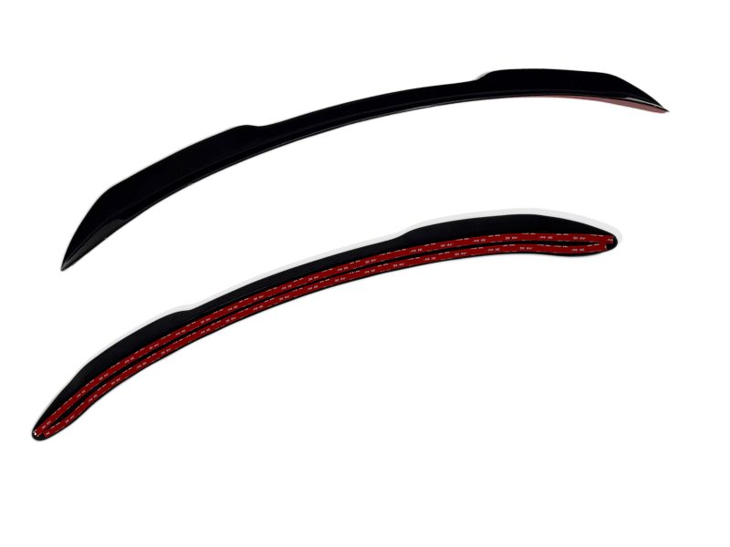 Two long, curved black objects with red inner lining resting on a white background.