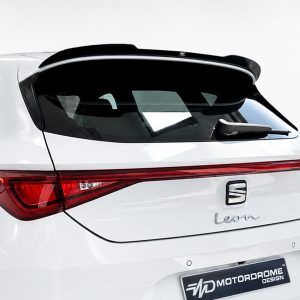 Rear three-quarter view of a white SUV showing a raised roof spoiler, dark rear window, and red tail lights with a 'Leon' badge on the tailgate.