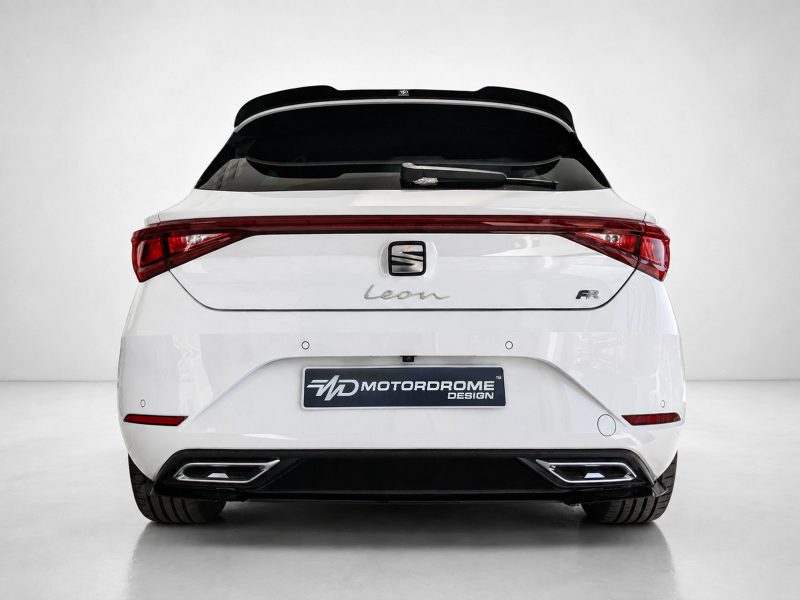 A-475_3jpg - OPSHOLDERS Rear view of a white SEAT Leon FR hatchback with red taillights and a Motordrome Design plate in a studio setting