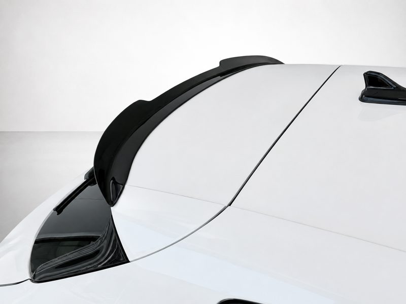 A-475_4jpg - OPSHOLDERS Close-up of a white car roof with black trim along the edge and a small rear spoiler/antenna visible at the top-right corner.