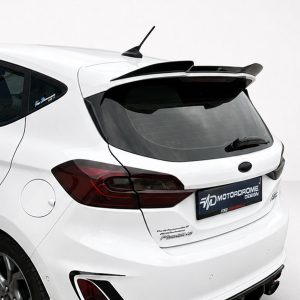 White hatchback rear shown with a spoiler and dark taillights, viewed from the left side of the vehicle door.