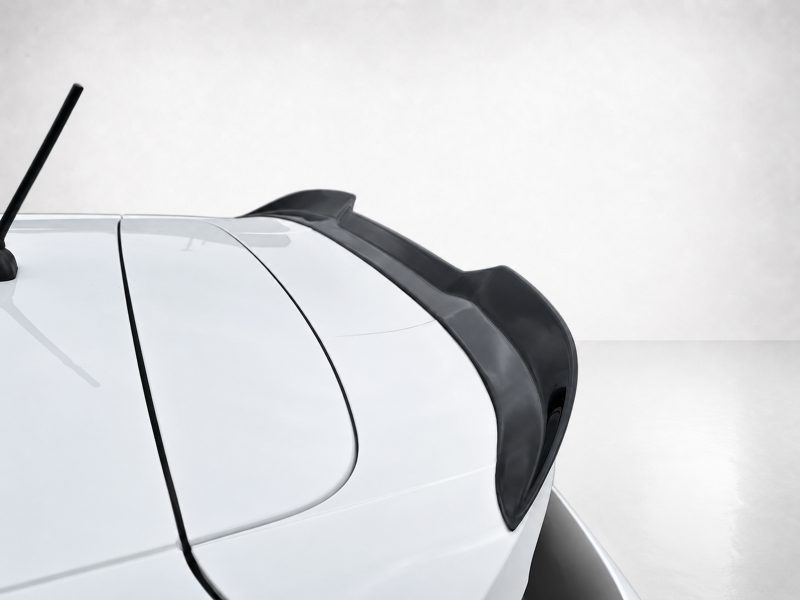 A-476_4jpg - OPSHOLDERS Close-up of the rear of a white car showing a black spoiler and rear wiper.