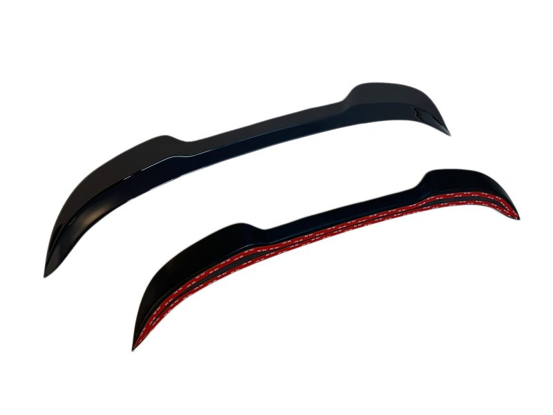 A-476_6jpg - OPSHOLDERS Pair of black, curved, blade-like components with a red interior edge, shown against a white background (aerodynamic fins or brackets).